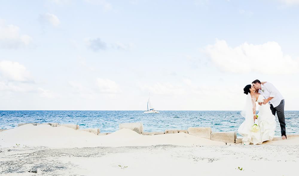 Wedding couple kissing on beach in Riviera Maya