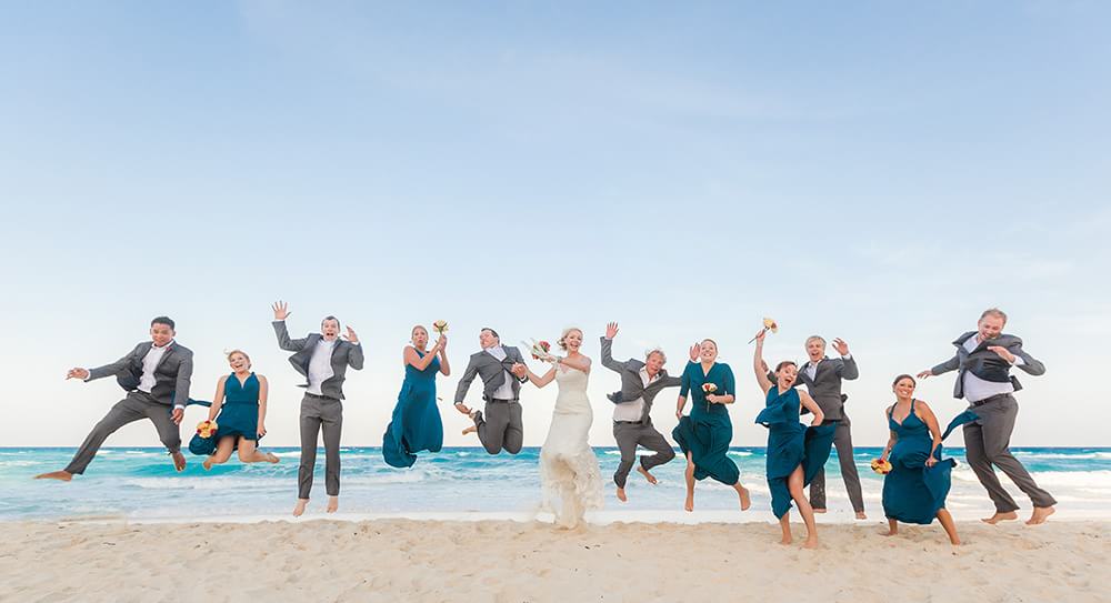 Wedding party jumping on Beach in Cancun