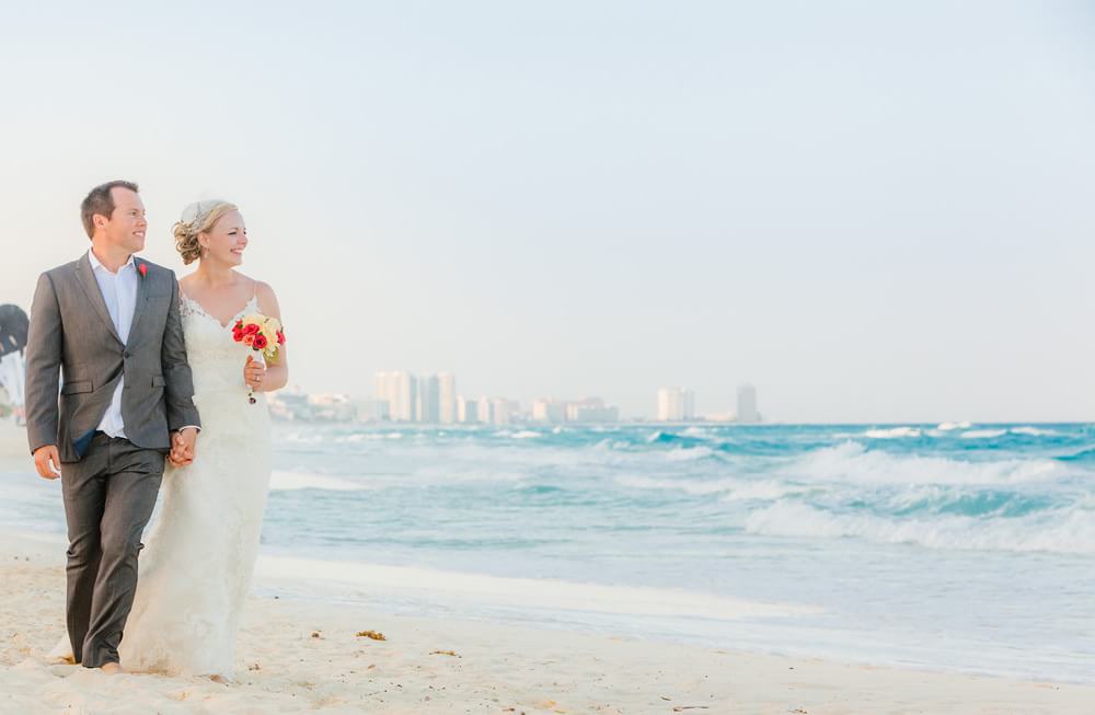 Wedding couple walking on beach in Cancun