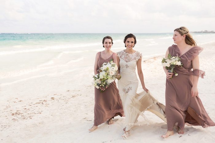 Bridesmaids walking on beach with great posture and looking skinner in their photographs
