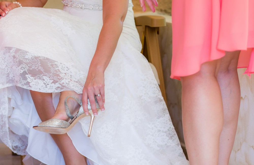 Bride put shoe on at Mexico Wedding