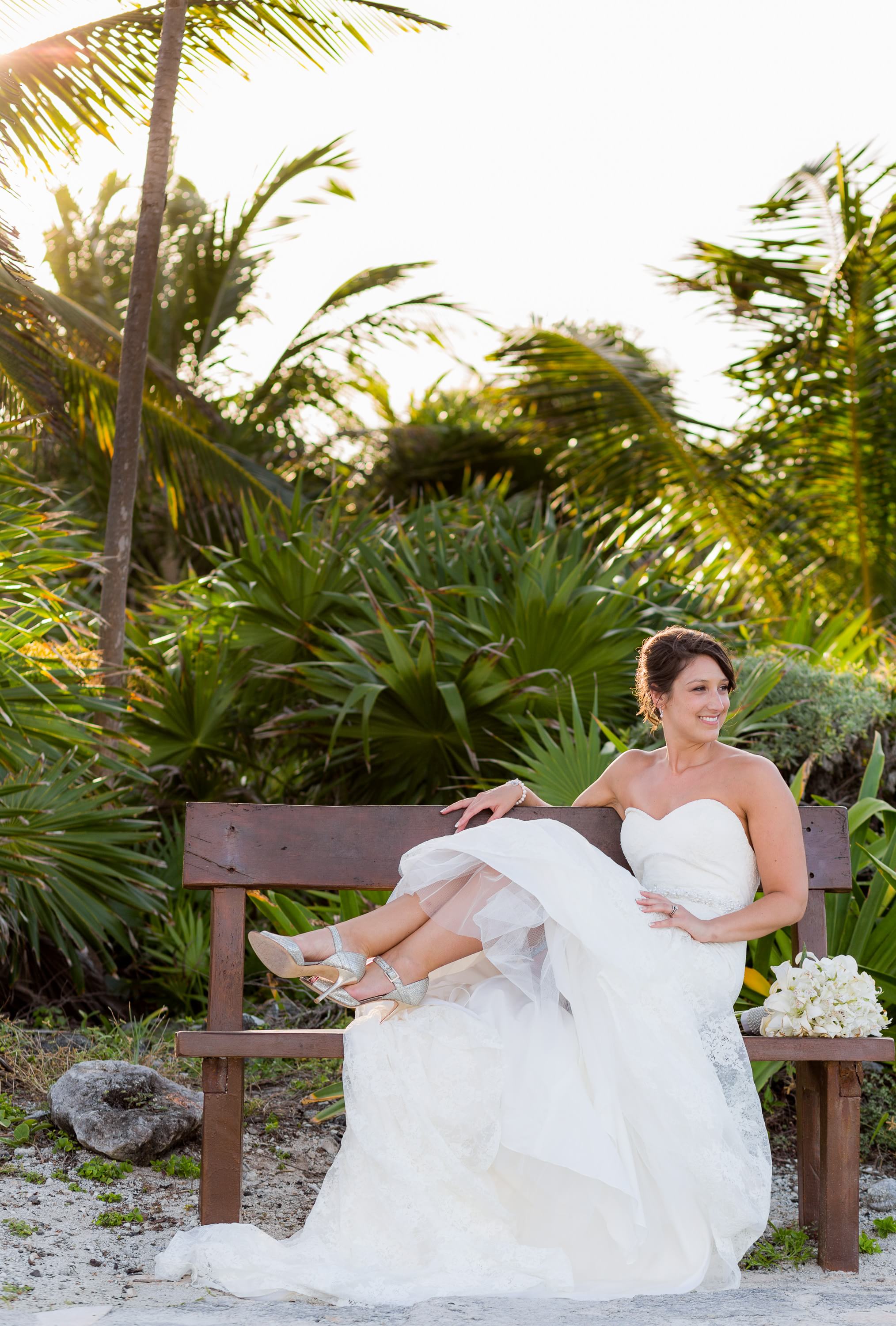 Bride sitting on bench at Grand Palladium Riviera Maya Wedding