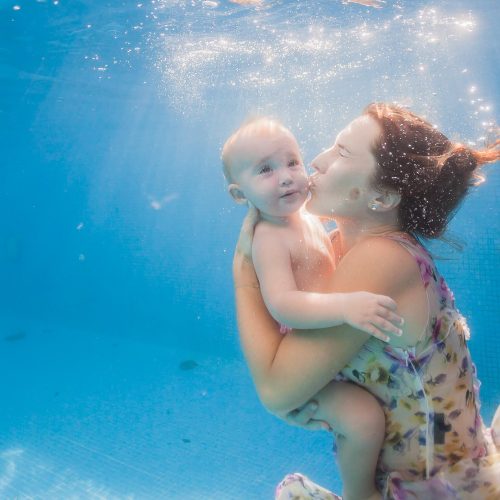 baby underwater with mother in Mexico