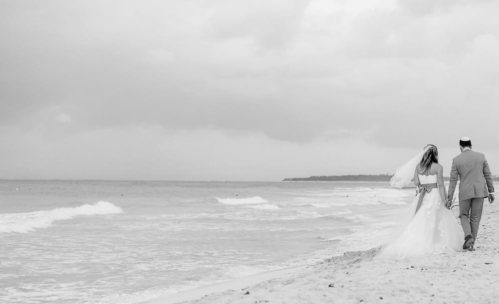 Couple walking on beach at Riviera Maya wedding