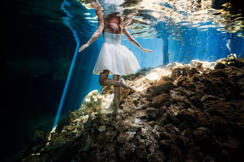 Bride underwater in Mayan Cenote Trash the dress Mexico