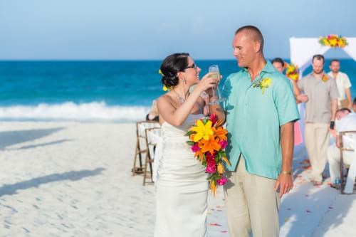 Amy and David toasting at their Destination Beach Wedding at Iberostar Lindo Mexico