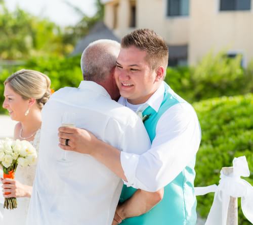 Groom smiling at his Ocean Coral and Turquesa Wedding