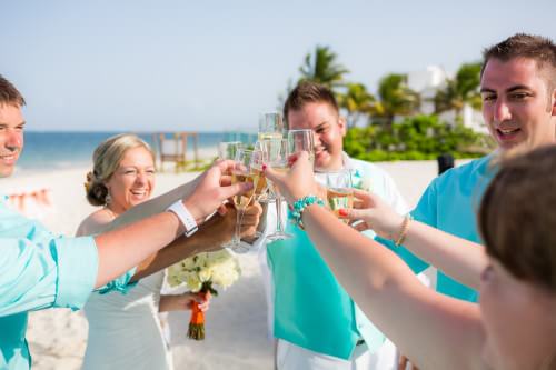Couple Toasting at their Ocean Coral and Turquesa Wedding