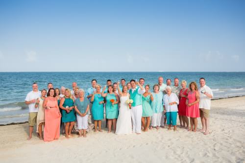 Group photograph at Ocean Coral and Turquesa Wedding