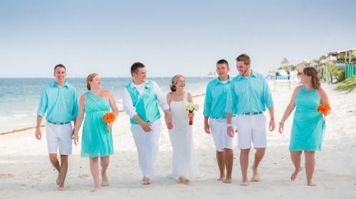 Bride and Groom walking down the beach at Ocean Coral and Turquesa Wedding