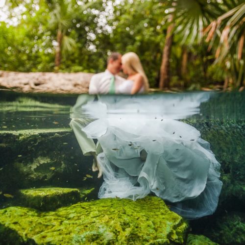 Bride and Groom holding each other in a cenote in Riviera Maya