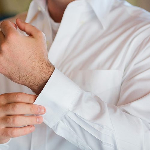 Close up of groom getting ready