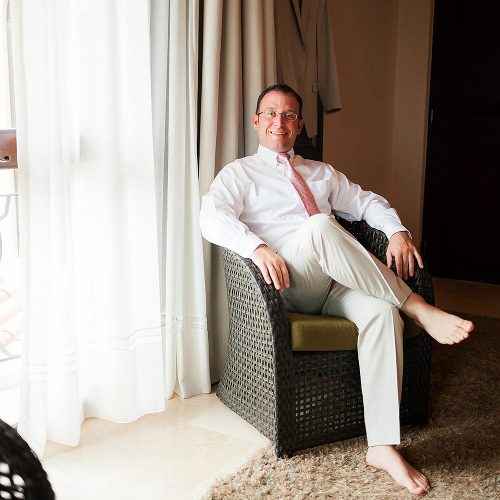 Portrait of groom sitting before wedding
