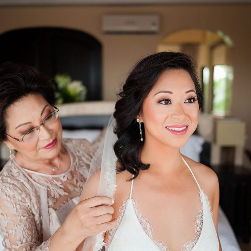 Mother helping bride before wedding in Tulum