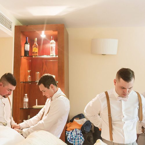 Groomsmen getting ready in room at Excellence Playa Mujeres wedding