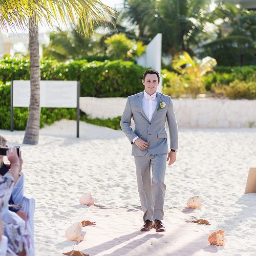 Groom walking down aisle at Excellence Playa Mujeres beach wedding