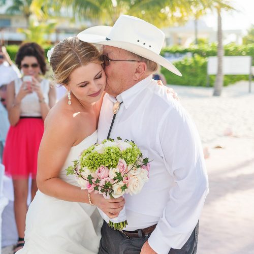 Father kissing bride after walking her down aisle at Excellence Playa Mujeres