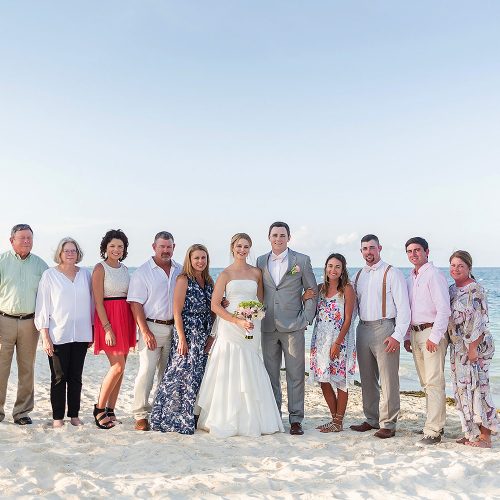 Family photograph on beach after wedding at Excellence Playa Mujeres