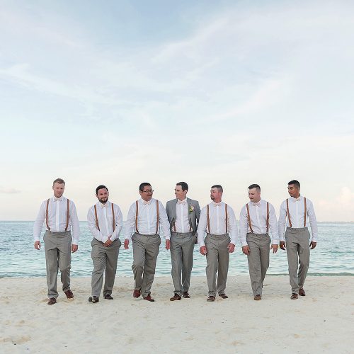 Groomsmen on beach after wedding at Excellence Playa Mujeres
