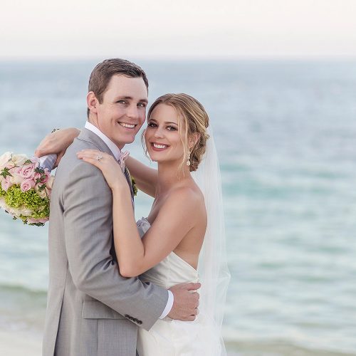 Bride and groom on beach after wedding at Excellence Playa Mujeres