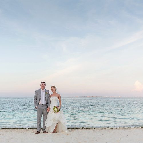 Bride and groom on beach at Excellence Playa Mujeres