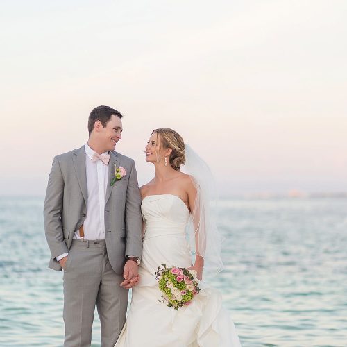 Bride and groom on beach at Excellence Playa Mujeres