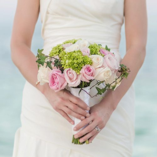 Close up of bridal bouquet with ocean in background