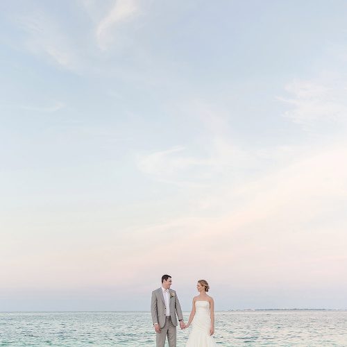 Bride and groom on beach at Excellence Playa Mujeres