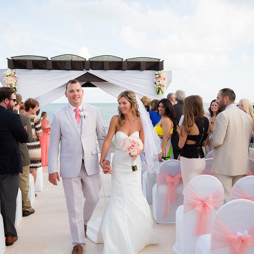 Bride and groom walking after wedding ceremony at NOW Jade Riviera Cancun
