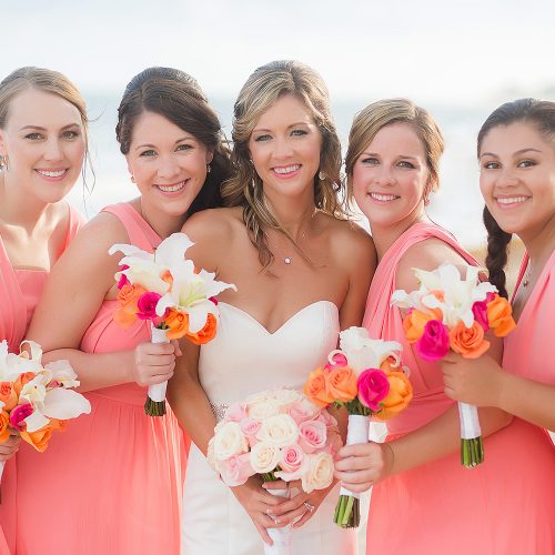 Bride and bridesmaids at wedding on beach at NOW Jade Riviera Cancun