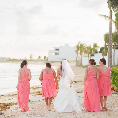 Bridesmaids walking on beach at NOW Jade Riviera Cancun