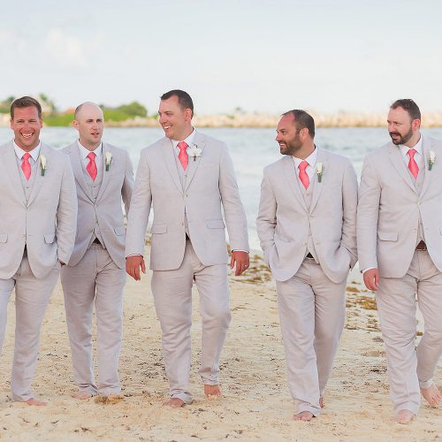 Groomsmen walking on beach at NOW Jade Riviera Cancun wedding