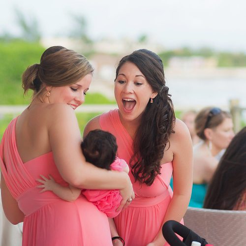 Bridesmaids having fun at cocktail party with baby at NOW Jade Riviera Cancun