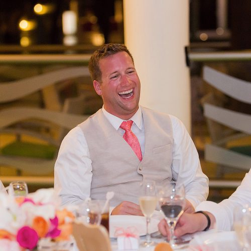 Groomsman laughing at speech at NOW Jade Riviera Cancun wedding