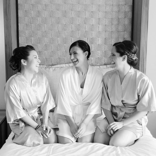 Bride and bridesmaids on bed at Secrets Akumal Riviera Maya wedding