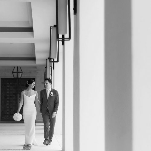 Bride and groom walking in hallway at Secrets Akumal Riviera Maya
