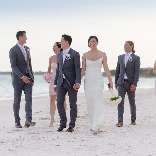 Bridal party walking on beach at Secrets Akumal Riviera Maya