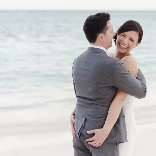 Bride grabbing grooms bum on beach and having fun at Secrets Akumal Riviera Maya