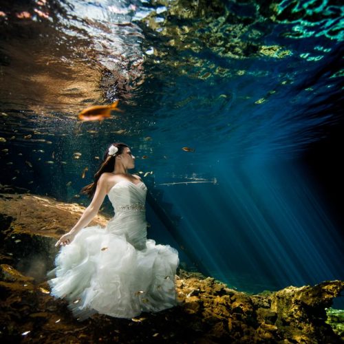 Bride underwater in Trash the Dress in Mayan Cenote, Mexico