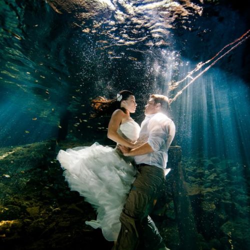 Bride and groom underwater in Mayan Cenote Trash the Dress