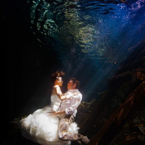 Bride and Groon underwater in Mayan Cenote Trash the dress.