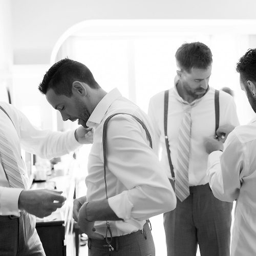 Black and white photo of groomsmen getting ready at Riviera Maya