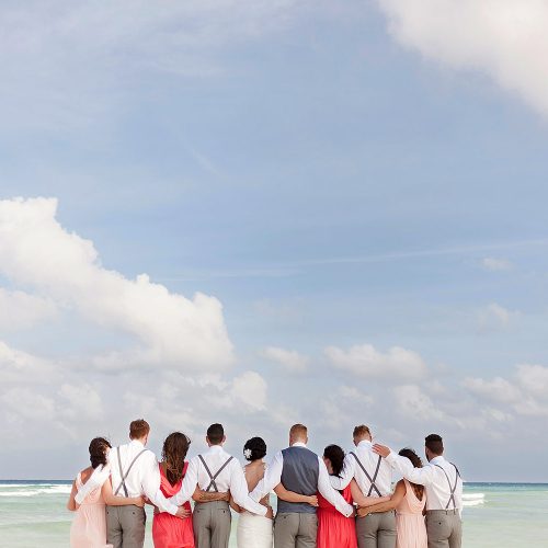 Bridal party on the beach looking at the ocean at Playa del Carmen wedding photography