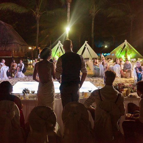 Bride and groom giving speech at wedding reception in Riviera Maya