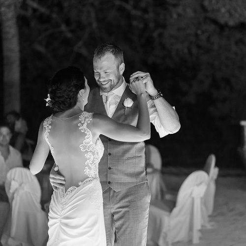 Black and white photography of bride and grooms dancing at Riviera Maya wedding