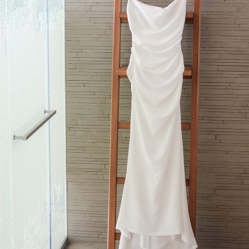Wedding dress hanging in room at Secrets The Vine Cancun
