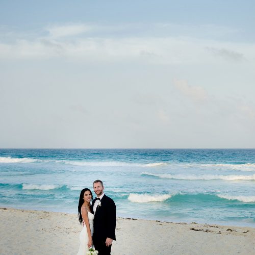 Bride and groom on beach at Secrets The Vine Cancun