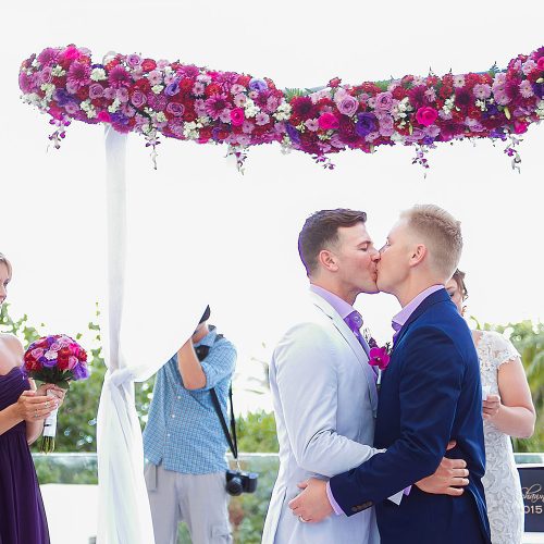 Grooms first kiss at gay wedding ceremony