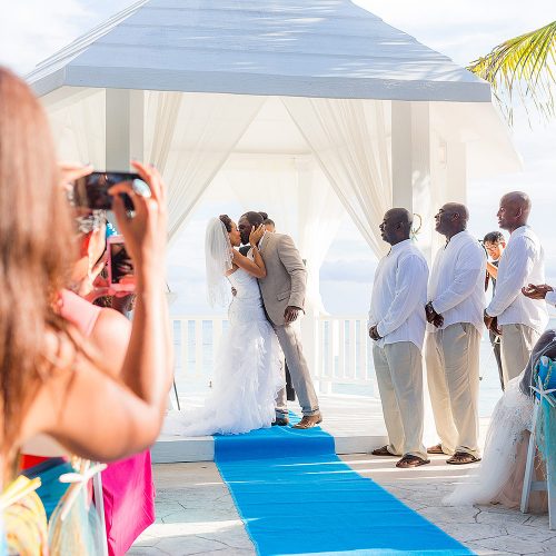 Bride and grooms first kiss at wedding ceremony
