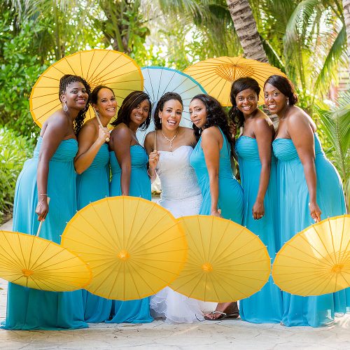 Bride and bridesmaids with parasols after wedding ceremony